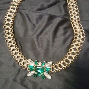 Golden necklace with green stone